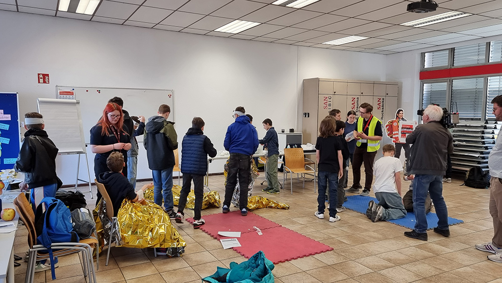 Jungen und Mädchen üben Erste Hilfe